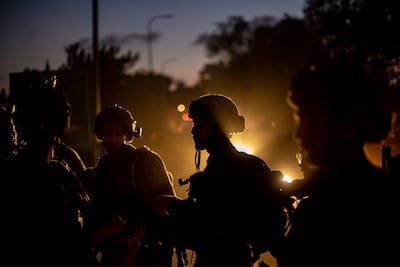 Israeli soldiers near Be'eri kibbutz where 108 Israeli bodies were found. EPA