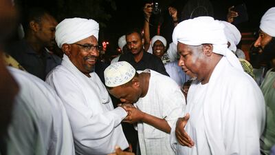 Sudanese President Omar Al Bashir greets Sufi Muslim clerics at the presidential palace in Khartoum on January 3, 2019. AFP