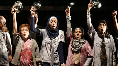 Amateur cast of Jordanian and Syrian refugee children dressed in worn-out clothes bang on tables demanding meat, Kebab and chicken at an orphanage, in the first ever Arabic language adaptation of "Oliver" in Amman, Jordan. Salah Malkawi for The National