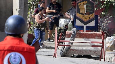 A Fatah fighter shoots his weapon during clashes in the Ain Al Hilweh Palestinian refugee camp, near the port city of Sidon, southern Lebanon, on August 25, 2015. Ali Hashisho/Reuters