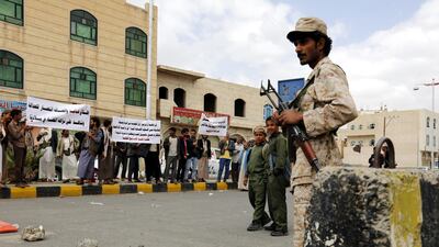 Bahai members hold banners during a protest against the trial of member of leader Hamed bin Haydara, outside the state security court in Sanaa in 2016. EPA