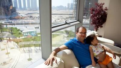 Ashraf Metwally, who says rent-to-own is the only “reasonable” way to buy flats, with his daughter, Jumana, in their new home in Sun Tower on Reem Island in Abu Dhabi. Silvia Razgova / The National