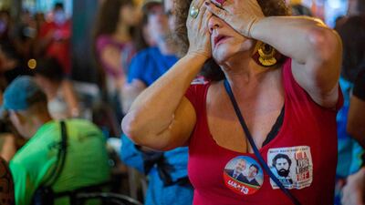 A supporter of Brazilian presidential candidate for the Workers' Party Fernando Haddad reacts during the general election vote count in Sao Salvador square, Rio de Janeiro. AFP