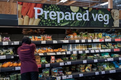 A worker replenishes items in the produce section of a Sainsbury's supermarket in London, in July 5, 2022. Bloomberg