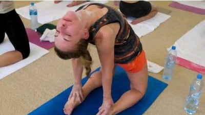 The National's Melanie Swan performs camel pose at a Bikram Yoga class at Club Stretch in Dubai Marina. Razan Alzayani / The National