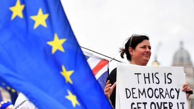 A pro-EU demonstrator holds a placard during an anti-Brexit protest outside the Houses of Parliament in London. Ben Stansall/ AFP