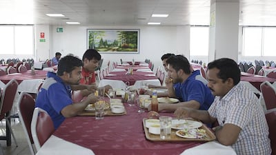 Residents in the dining room at Workers’ Village in Mussaffah say they are happy with the quality of food there. Lee Hoagland / The National