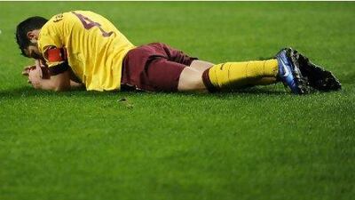 Cesc Fabregas, the Arsenal captain, lies on the pitch in Braga during Tuesday’s Champions League defeat. The hamstring he injured will keep him out of action for at least two weeks.