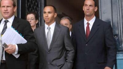 Lewis Hamilton, centre, leaves the FIA's headquarters in Paris.