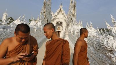 Buddhist monks take a tour at Wat Rong Khun also know as the White Temple designed by Thai visual artist Chalermchai Kositpipat in Chiang Rai Province, Thailand. Jorge Silva / Reuters