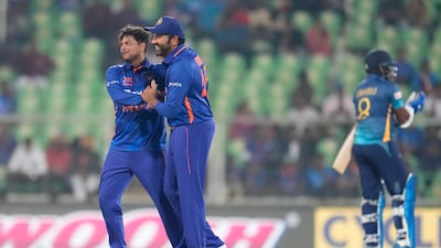 Kuldeep Yadav, left, celebrates with captain Rohit Sharma after dismissing Lahiru Kumara. AP