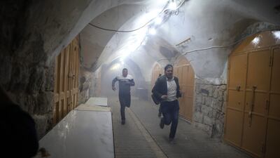 Palestinians flee clashes with the Israeli army in the West Bank city of Hebron after a protest against Israel's plans to change the status quo in the Ibrahimi mosque, also known as the Cave of the Patriarchs and building a lift to serve Jewish worshippers. EPA