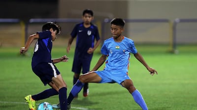 A La Liga Academy player, left, challenges a Minerva Academy player.