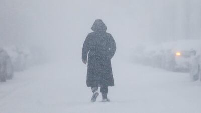 A woman walks down the street in Long Beach, New York. Shannon Stapleton / Reuters
