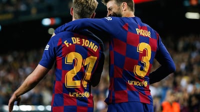 Barcelona's Spanish defender Gerard Pique is congratulated by teammate Frenkie De Jong after scoring. AFP