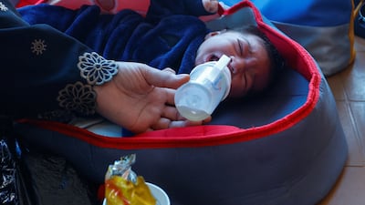 A baby is fed amid the war, while those with dual citizenship await for permission to leave Gaza. Reuters