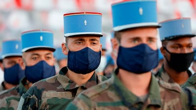 French soldiers of 2nd Regiment de Dragons, who worked during the coronavirus pandemic, practice their marching formation before the July 14 Bastille Day Parade at the Place de la Concorde in Paris. This year's event is being held as a tribute to health workers fighting the pandemic. AFP