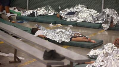Young boys sleep in a holding cell where hundreds of mostly Central American immigrant children are being processed and held at the US Customs and Border Protection Nogales Placement Center in Nogales, Arizona. AP Photo/Ross D. Franklin