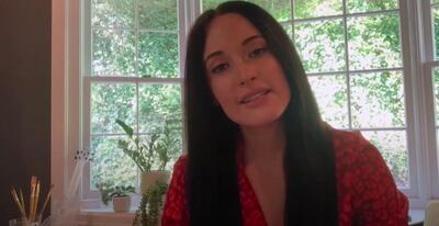 Has Kacey Musgrave been getting arty in isolation? Paint brushes can be seen behind her. YouTube