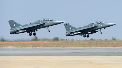 A pair of Tejas during a display on the second day of the Aero India exhibition at Yelahanka Air Force base in Bangalore.