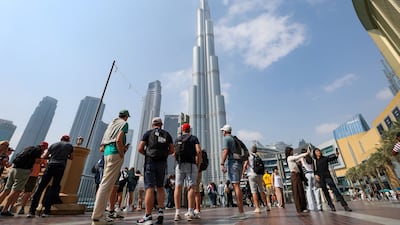 Tourists in Downtown Dubai, three weeks before the war began. August was the busiest month for visitors since February. Chris Whiteoak / The National