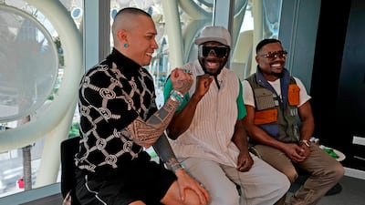 Taboo, left, fist-bumps will.i.am as the band meet the press at the Expo site. AP