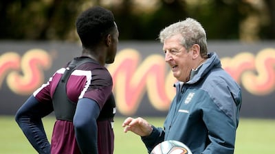 Roy Hodgson talks with Daniel Sturridge, wearing one of the sweat vests meant to duplicate Brazilian heat conditions, at the England's training camp in Portugal. Richard Heathcote / Getty Images / May 21, 2014