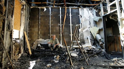 A local resident sits in his home, damaged by recent shelling, in the rebel-controlled city of Donetsk on July 18, 2017. Alexander Ermochenko / Reuters