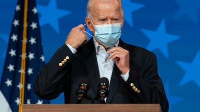 Democratic presidential candidate former Vice President Joe Biden removes his face mask to speak at The Queen theater in Wilmington, Delaware. AP Photo