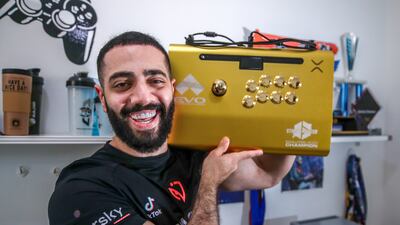 Amjad 'AngryBird' Al Shalabi received a gold-plated arcade joystick for his win at Evo 2023. All Photos: Victor Besa / The National