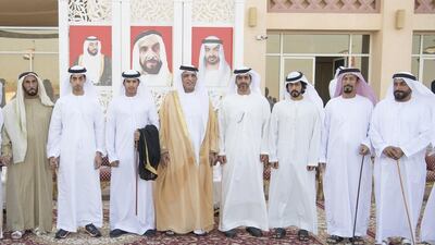 Sultan bin Ali Al Khatri (L), Sheikh Khaled bin Zayed, Chairman of the Board of Zayed Higher Organization for Humanitarian Care and Special Needs (ZHO) (2nd L), Sheikh Saud bin Saqr Al Qasimi, Ruler of Ras Al Khaimah (4th L), Sheikh Hamed bin Zayed, Chairman of the Crown Prince Court of Abu Dhabi and Abu Dhabi Executive Council Member (5th L), Sheikh Khalifa bin Tahnoon bin Mohammed, Director of the Martyrs’ Families’ Affairs Office of the Abu Dhabi Crown Prince Court (6th L) and Muftah Ali Al Khateri (R) stand for a photograph during the wedding reception of Hilal Ateeq Al Khateri (3rd L), in Ras Al Khaimah. Hamad Al Kaabi / Crown Prince Court — Abu Dhabi