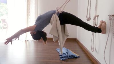 Suzette Garza uses a rope, anchored to the wall, to ‘open’ her back and chest. Courtesy Samar Al Sayed