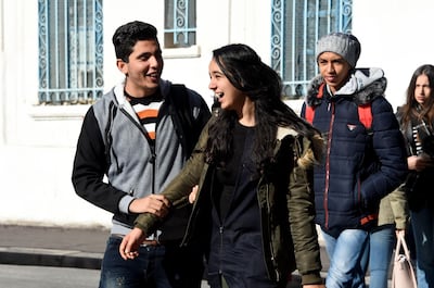 Both boys and girls think the dress code is unfair to the female pupils. In this picture, Tunisian students walk outside their school in Bizerte on December 11, 2017. Fethi Belaid / AFP