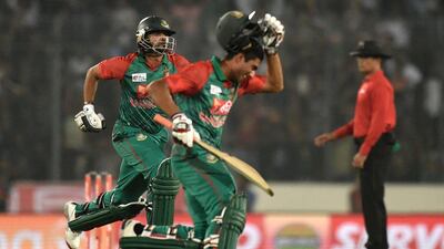 Bangladesh cricket captain Mashrafe Bin Mortaza (L) and Mohammad Mahmudullah (C) react after winning the Asia Cup T20 cricket tournament match between Bangladesh and Pakistan at the Sher-e-Bangla National Cricket Stadium in Dhaka on March 2, 2016. / AFP / MUNIR UZ ZAMAN