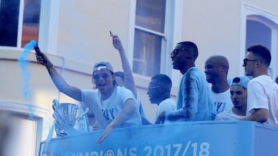 Manchester City's Leroy Sane (L) holds a flare during a bus parade to celebrate their English Premier League title win, in Manchester. Nigel Roddis / EPA