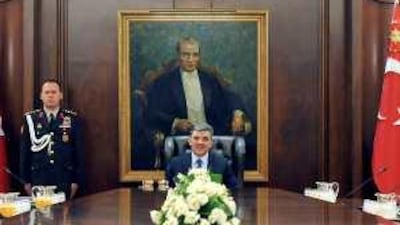 Abdullah Gul, the Turkish president, sits in between Recap Tayyip Erdogan, the prime minister, left, and gen Ilker Basbug. Mr gul signed a bill that allows civilian courts to investigate the military.