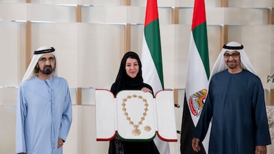 President Sheikh Mohamed and Sheikh Mohammed bin Rashid, Vice President and Ruler of Dubai, present a Union Medal to Reem Al Hashimy, Minister of State for International Co-operation, for her work during Expo 2020 Dubai. Hamad Al Kaabi / Ministry of Presidential Affairs