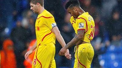 Liverpool's Raheem Sterling, right, and Steven Gerrard walk off the pitch after their English Premier League match against Crystal Palace at Selhurst Park in London November 23, 2014. Liverpool lost their fourth straight and will head into Champions League competition on Wednesday. REUTERS/Eddie Keogh
