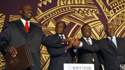 From left: Zimbabwean MDC (Movement for Democratic Change) breakaway faction leader Arthur Mutambara, Zimbabwe's president Robert Mugabe, opposition's leader Morgan Tsvangirai and South African Thabo Mbeki pose after signing the power-sharing accord on September 15, 2008 in Harare. Mbeki said the region and Africa had to extend a helping hand to Zimbabwe and that getting seeds, fertilizer and fuel to the country was a matter of urgency with rains approaching. Desmond Kwande / AFP
