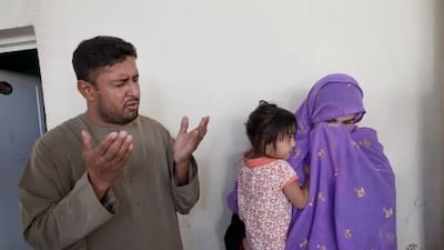 The relatives of four-year-old Moosa Mukhtiar Ahmed pray. Rashid al Rashidi, 30, was executed by firing squad for raping and killing their son in 2009.