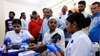 Labourers receive basic health check-ups during a visit to Al Naboodah labour camp in Al Muhaisna.