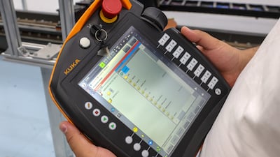 Engineer Abelrahman Youssef operates the robotic arm