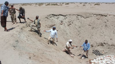 Yemeni security forces inspect unexploded ordnance confiscated from Houthi rebels. Saleh Al Obeidi / AFP
