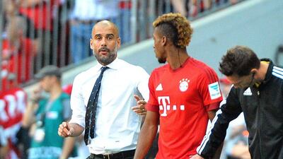 Bayern Munich coach Pep Guardiola, left, gives instructions to Kingsley Coman during the German Bundesliga match against Augsburg in Munich, Germany, 12 September 2015. EPA/STEFAN PUCHNER