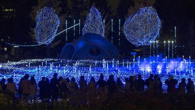 Visitors watch an illumination display Tokyo Midtown which features choreographed lighting, a soundtrack and simulated fireworks. Thomas Peter / Reuters