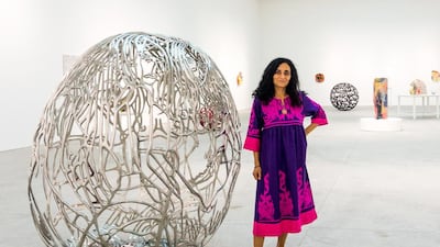Egyptian artist Ghada Amer with her work The Blue Bra Girls (2012). Courtesy Leila Heller Gallery