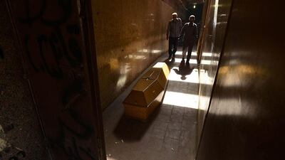 A coffin lies in a morgue before being transferred to the Virgin Mary Coptic Christian church in Cairo, Egypt. Ahmed Mohamed / AFP