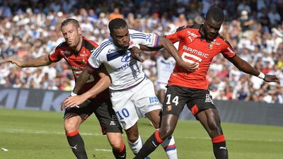 Lyon's Alexandre Lacazette is challenged by Rennes' Sylvain Armand, left, and Fallou Diagne, right, on Saturday during their Ligue 1 contest. Jean-Philippe Ksiazek / AFP / August 22, 2015