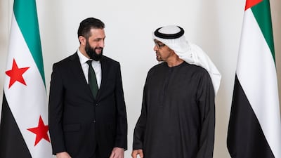President Sheikh Mohamed and President of Syria Ahmad Al Shara stand for a photograph before a meeting at Al Shati Palace. Ryan Carter / UAE Presidential Court