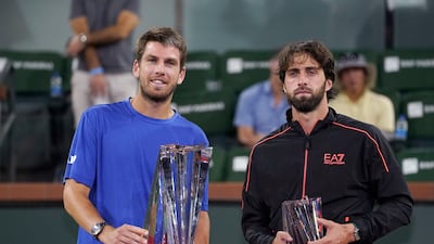 Cameron Norrie, left, of Britain, and Nikoloz Basilashvili, of Georgia, stand with their trophies after Norrie defeated Basilashvili in the singles final at the BNP Paribas Open tennis tournament Sunday, October 17, 2021, in Indian Wells. AP Photo